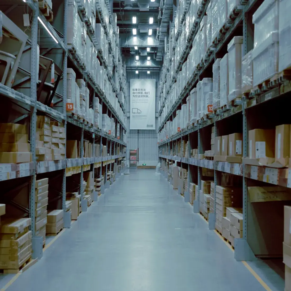 Stocked racking along an aisle in a distribution warehouse