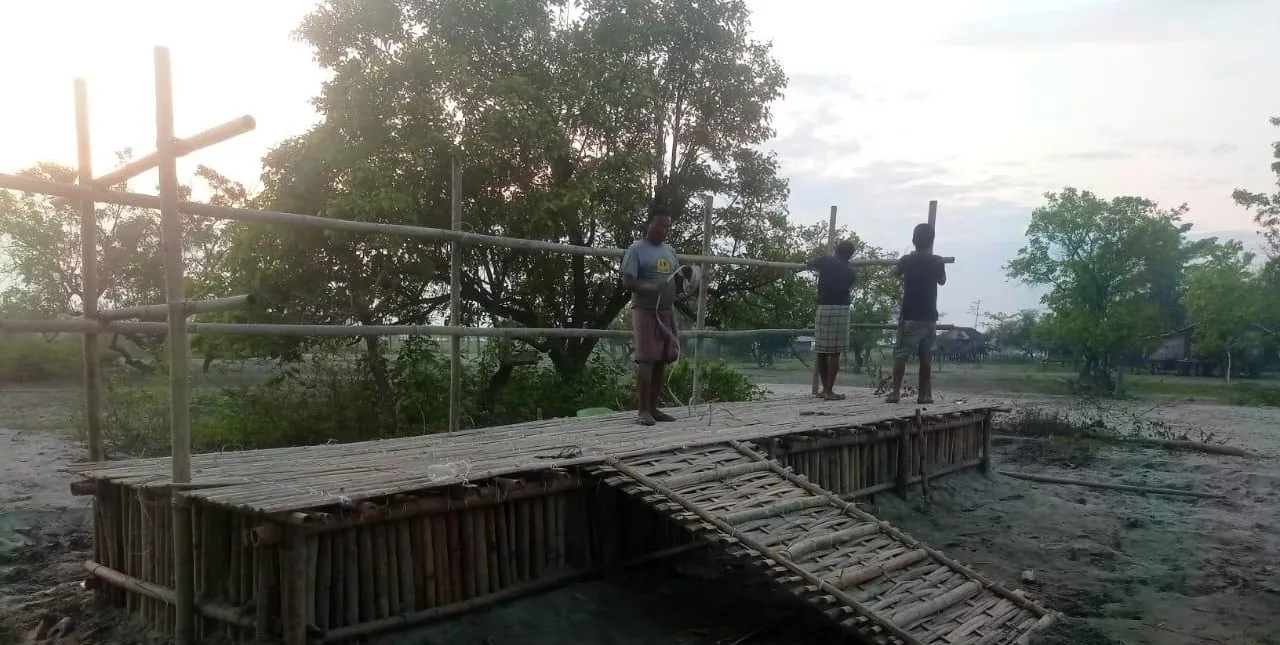 Workers on a bamboo-shuttered platform at a Mazel Infratech site